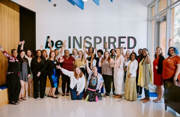 Rolonda Hernandez with a room of attendees celebrating at a Strategic AF speaking event